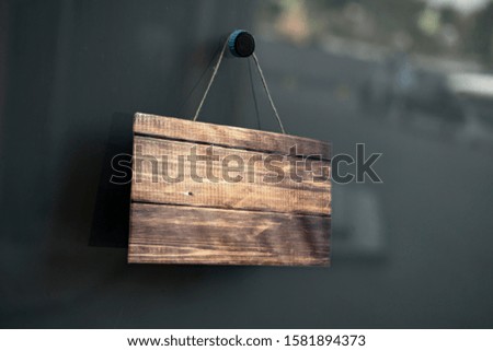 simple sign board frame hanging on the wall of the building exterior with copy space mock up, design for text