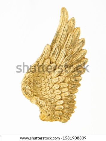Golden angel wing isolated on white backgorund. Beautiful mythological wing. Gold design element. Divinity concept. Royalty-Free Stock Photo #1581908839