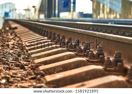 Railway sleepers and rails close-up. Iron bolts and connections. Railway background. Railway crossing. Royalty-Free Stock Photo #1581921895