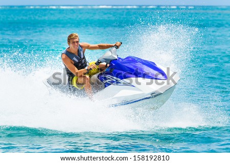 Young Man on Jet Ski, Tropical Ocean, Vacation Concept Royalty-Free Stock Photo #158192810