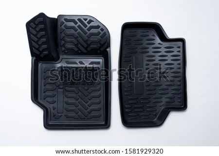 black set of mats for car made of thermoplastic elastomer on a white background Royalty-Free Stock Photo #1581929320