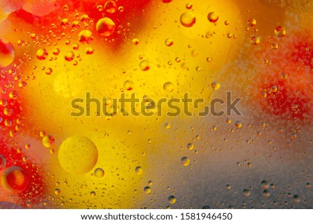 Bubbles of oil on water and colorful abstract blurred background 