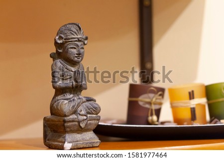 Toy stone figure on the table in modern interior