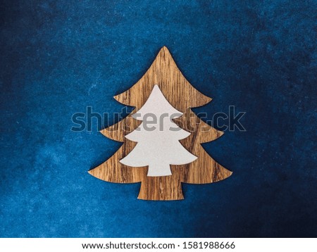 Classic blue color this year with a decor element in the form of a Christmas tree.  Place for text.  Christmas and New Year concept.