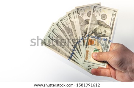 100 dollar banknote in hand shadow falling on white background