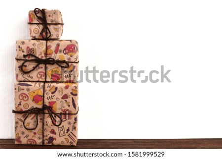 photos of boxes in red and brown gift boxes are on a wooden surface; brown and red gift boxes on a white background