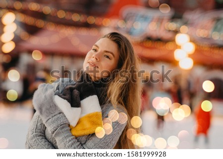 Beautiful woman is enjoy to be at ice-skate on the Red Square rink, Moscow, Russia