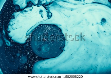 Color paint drops in water. Ink swirling underwater. Cloud of silky ink collision on white background. Colorful abstract smoke explosion animation. Close up camera view.