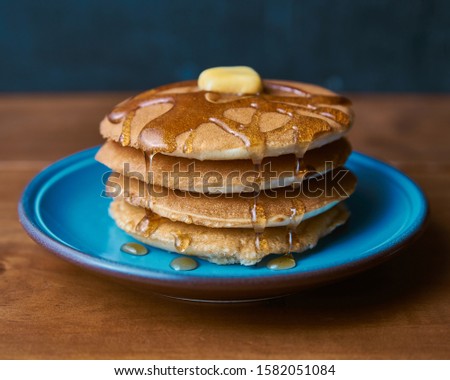 Delicious hot pancakes hotcakes with maple syrup on a wood table Royalty-Free Stock Photo #1582051084