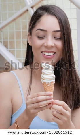 Ice cream, girl, lady, Sorvete. Picture of a beautiful young girl eating ice cream ( Mulher jovem segurando sorvete em cone de waffle ).
