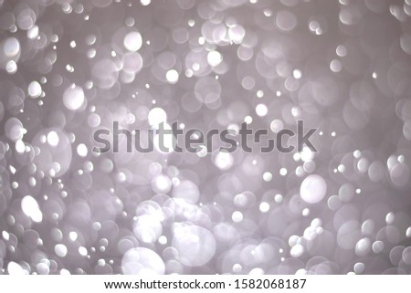 Abstract bokeh lights with a light gray background
