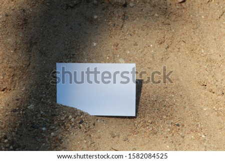 the white paper for text or message with sandy beach background