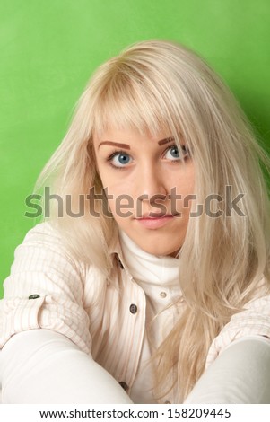 Portrait of an attractive girl on a bright green background