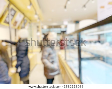 Blurred coffee shop, bakery and desserts background with people buying, looking, shopping, sitting, learning. Hanging out. Image for advertising, print, business, cafeteria