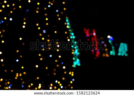 
Garland lights on the Christmas tree. Blurred defocused christmas background for design.