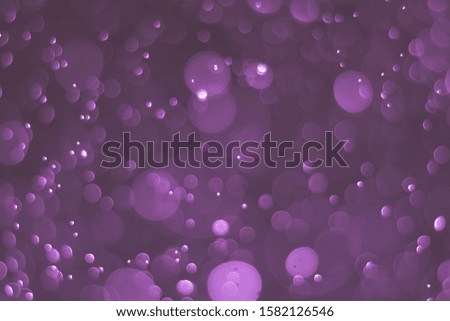 Abstract bokeh lights with light purple background
