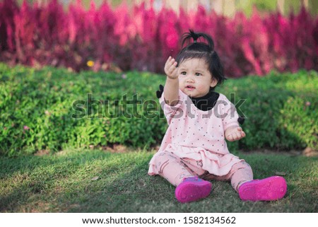portrait of cute baby travel at flowers garden