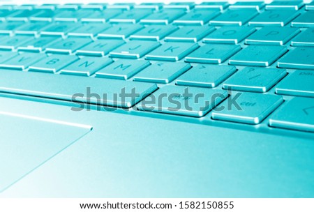 Closeup of a modern silver laptop computer keyboard. Laptop keyboard. Detail of the new and ergonomic computer keyboard. 