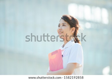 japanese young nurse stands outdoor