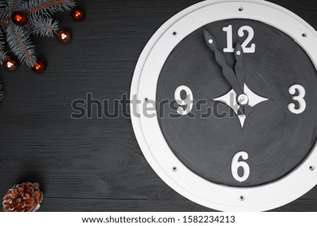 Near the change of the year. Greeting with Christmas and New Year by illustrating a clock with 23 hours and 55 minutes.