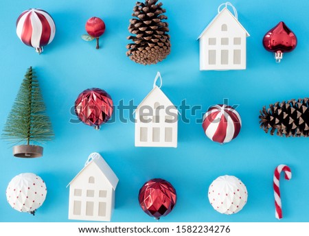 top view of Christmas and new year holidays concept with Pine cones, gift box, Christmas ball and Christmas decorations on blue table background.