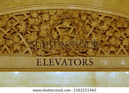 Inscription engraved on a wall: Elevators. 