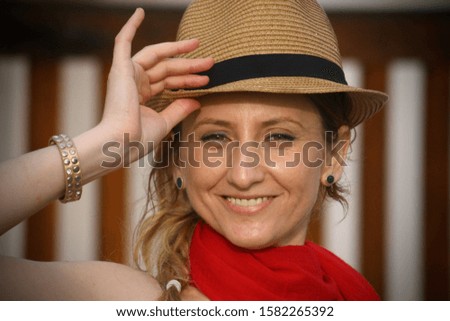 Happy woman wearing a hat and red outfit