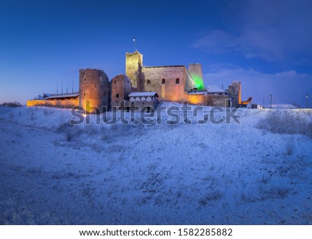 Ruins of the well-known medieval knight's castle in Rakvere. Castle with mystery environment, famous place and travel destination in Estonia. Amazing winter morning in Estonia.