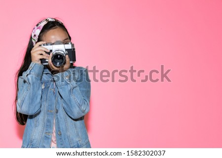 teenage girl taking a picture with a camera