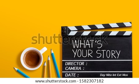 What's your story.text title on film slate.  and coffee cup on yellow background