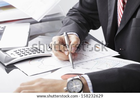 Close-up photo of a businessman analyzing financial data  