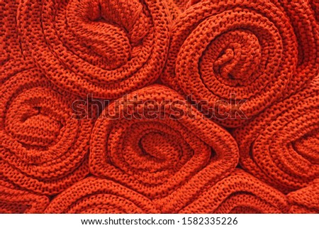 Texture of red wool big knit blanket. Large knitting. Plaid merino wool.                             