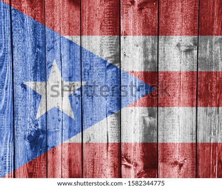 Flag of Puerto Rico on old wooden wall