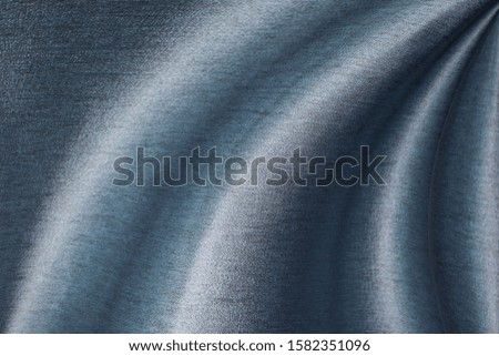 Streaks resemble water waves On a blue cloth