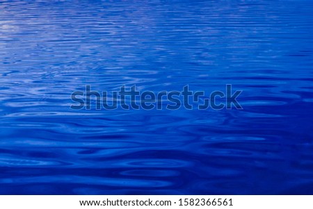 Water surface texture background. Blue lake water classic color Pantone 2020