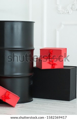 
black barrel on a white background with red gifts