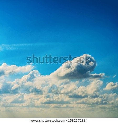 Fantastic soft clouds against blue sky, natural composition - square