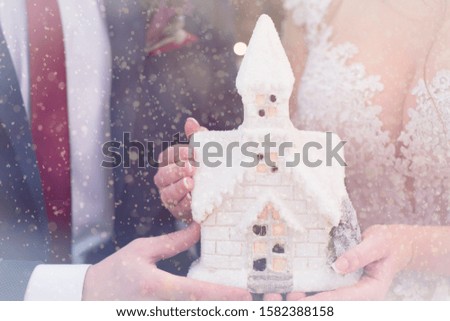 Christmas atmosphere house toy in the hands of lovers