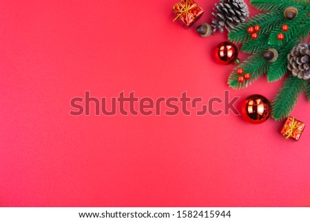 Christmas holidays composition, top view of red Christmas decorations on red background with copy space for text. Flat lay, winter, postcard template, new year concept.