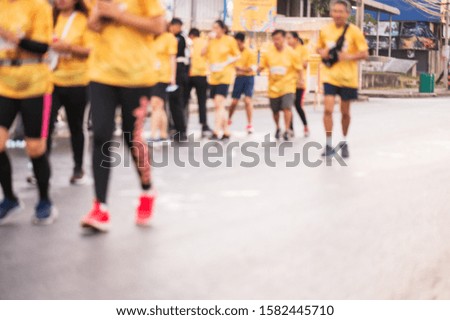 Out of focus and blurry background of marathon running race at the city road in the morning time.Outdoor exercise for healthy.