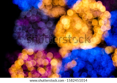 Abstract colorful soft blurred bokeh on black background. Shining and blurred circles lights bokeh background. For used wallpaper texture and background.