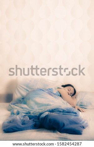 Image of young pretty lady with closed eyes lies in bed indoors. good sound sleep concept. home comfort in bed