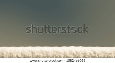 a  layer snow on a against of clear blue sky, background with copy space, tinted photo