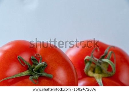 
red ripe tomatoes on a light background, close-up