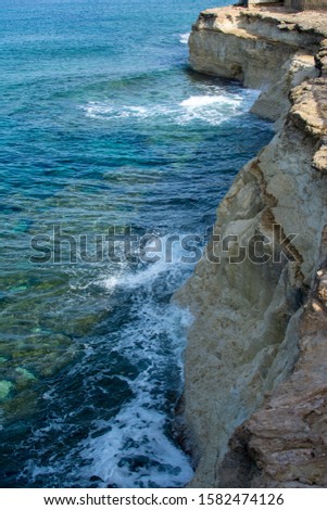 Rocky seaside in windy waves in the mediterranean sea