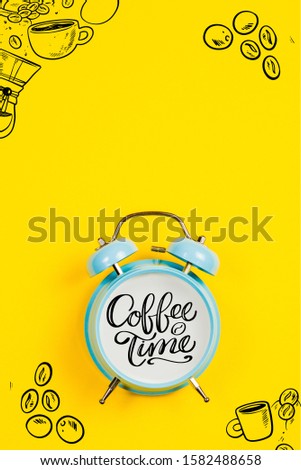 Blue alarm clock with graphics and text Coffee time on a yellow background