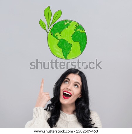 Save earth concept with happy young woman on a gray background