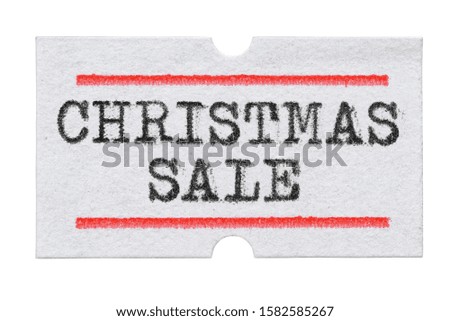 Christmas sale word printed with typewriter font on price tag sticker isolated on white background