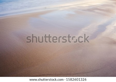 Soft nature background of coastline water and sand.