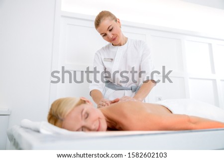 Body massage and spa treatment in modern beauty salon stock photo